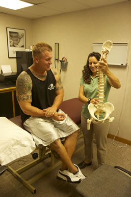 Lisa educating a patient about the Spine